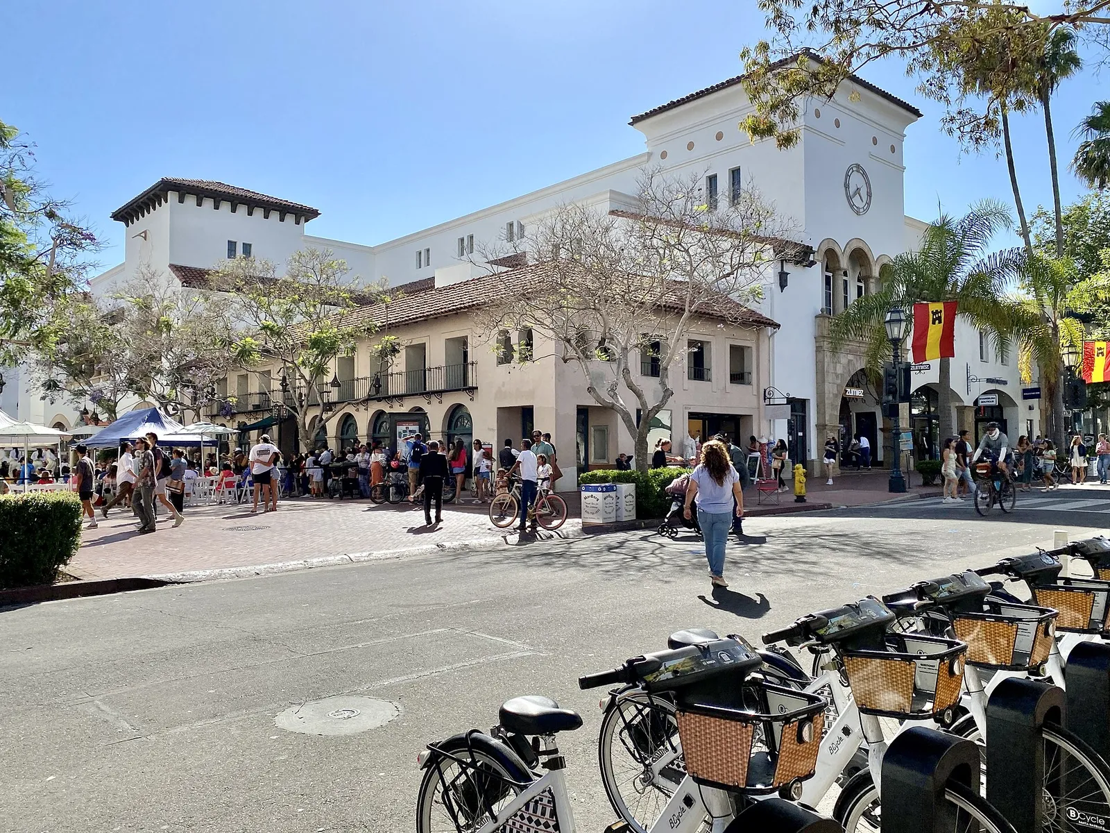 People walking and biking on State Street near Paseo Nuevo in downtown Santa Barbara
