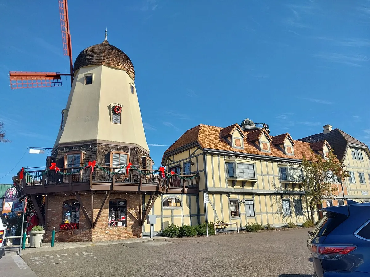 A windmill and Danish-style buildings on a sunny corner in Solvang
